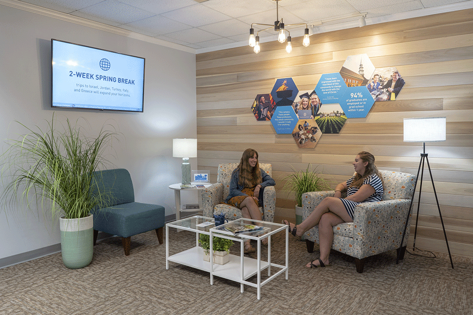Two women meeting in a foyer