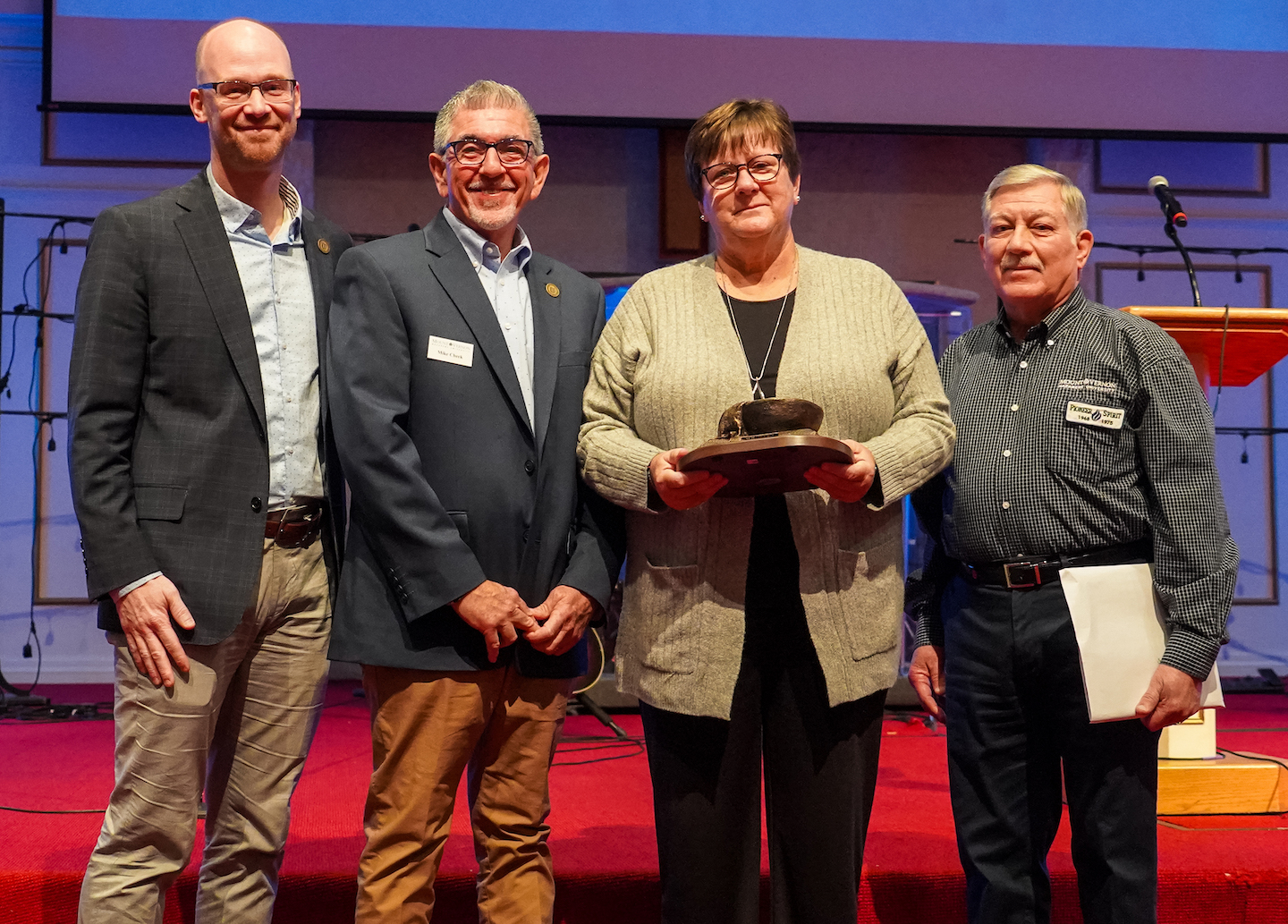 Jeana Howald was presented the Distinguished Alumni Award by the MVNU Alumni Association during Homecoming Chapel on Nov. 10. Pictured, from left, are, Dr. James Smith, Vice President for University Relations; Mike Cheek, Executive Director of Alumni Relations and Advancement; Jeana Howald; and Ron Keiser, President MVNU Alumni Association.