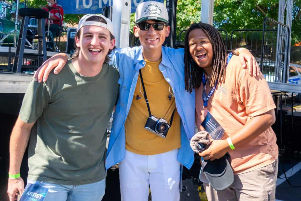 Tyler Maddux, left, Jensen Thompson and Nasir Cousin stop for a photo before taking the stage at Sonfest 2024.